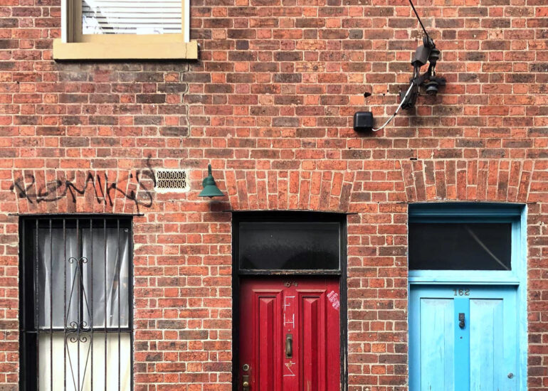 Red and blue doors on a brick terrace, Fitzroy, Melbourne inner north, hidden__north documentary photography