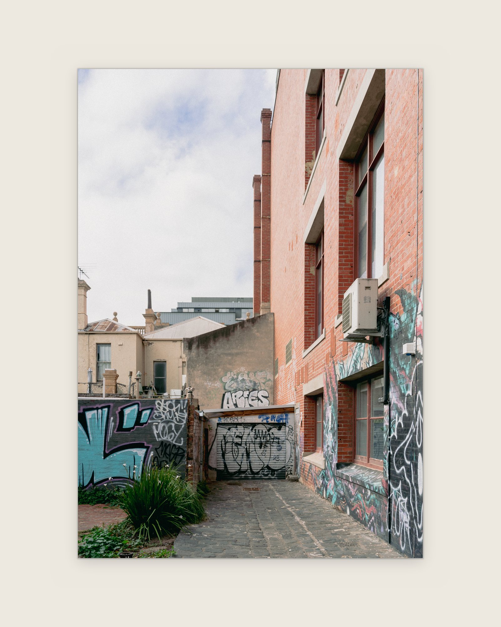 Bluestone laneway between graffiti-covered brick walls, Collingwood, Melbourne inner north, hidden__north documentary photography