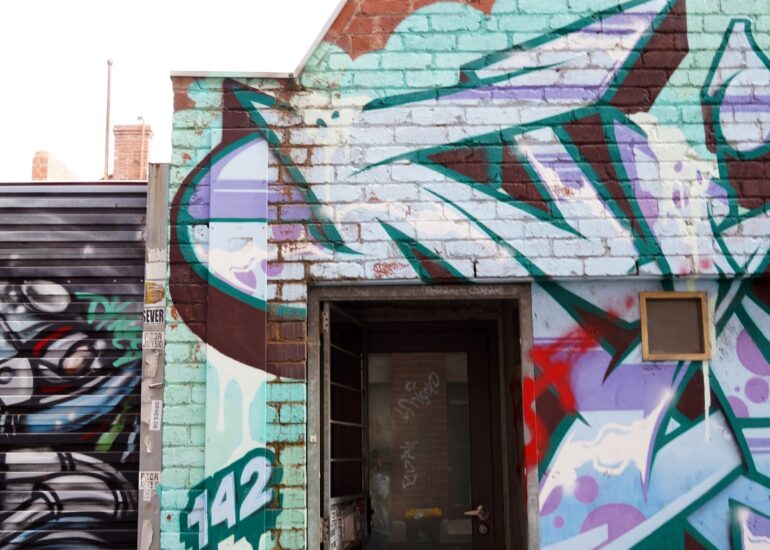 Doorway with teal graffiti mural surround, Melbourne inner north, hidden__north documentary photography