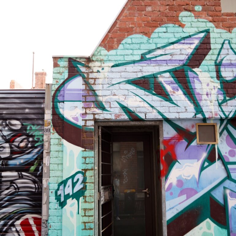 Doorway with teal graffiti mural surround, Melbourne inner north, hidden__north documentary photography