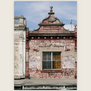 Weathered red and white Victorian shopfront pediment, Carlton North, Melbourne inner north, hidden__north documentary photography