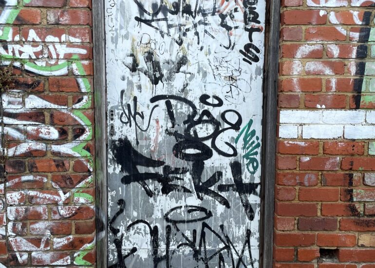 White tagged door, brick archway, Melbourne inner north, hidden__north documentary photography