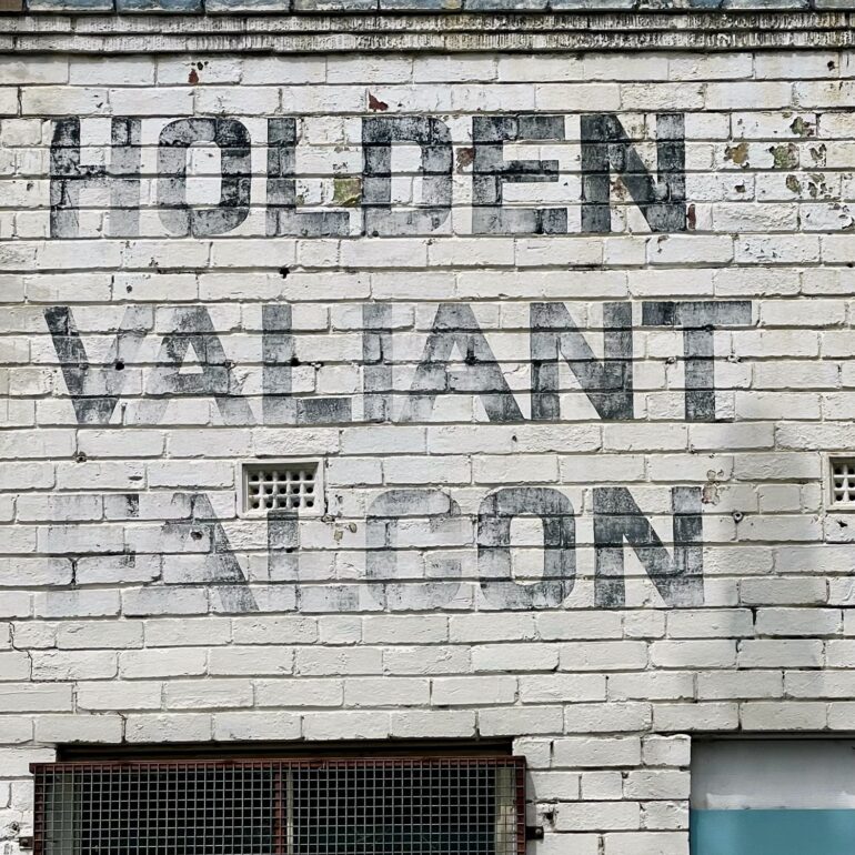 Faded Holden, Valiant and Falcon lettering painted on whitewashed brick, Melbourne inner north, hidden__north documentary photography