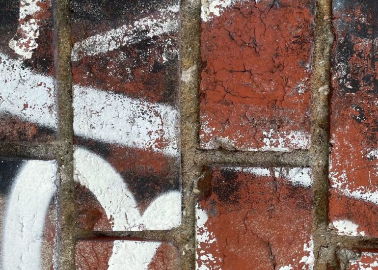 White painted marks over a rusted grille and brick, Melbourne inner north, hidden__north documentary photography