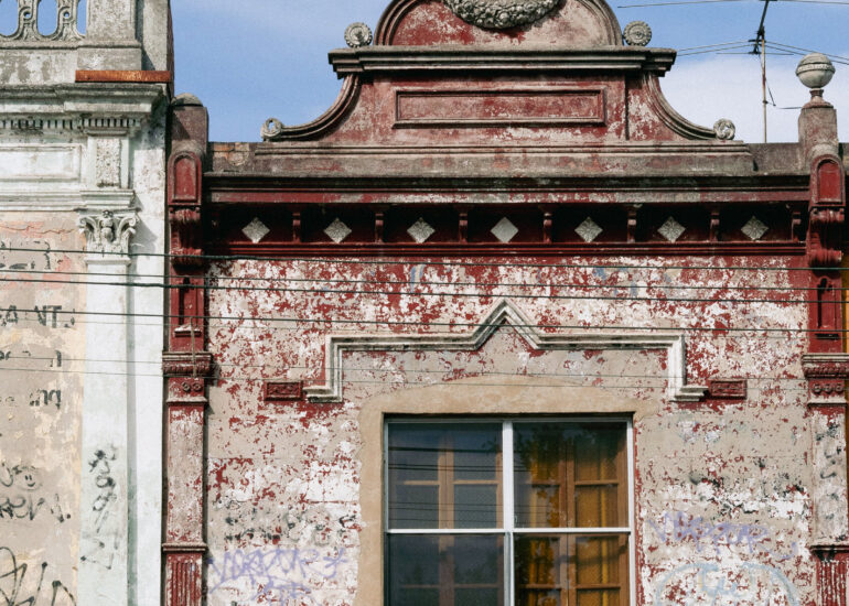 Victorian parapet with peeling red paint, Melbourne inner north, hidden__north documentary photography