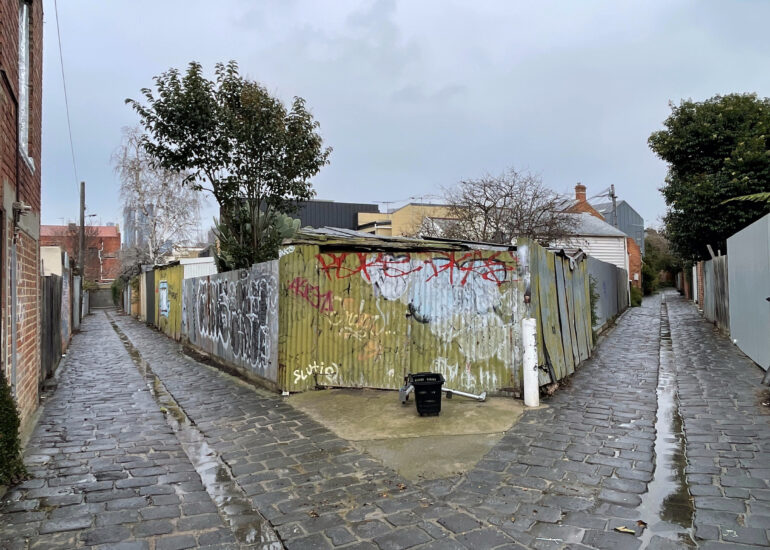 Wet bluestone laneway splitting in two, Melbourne inner north, hidden__north documentary photography