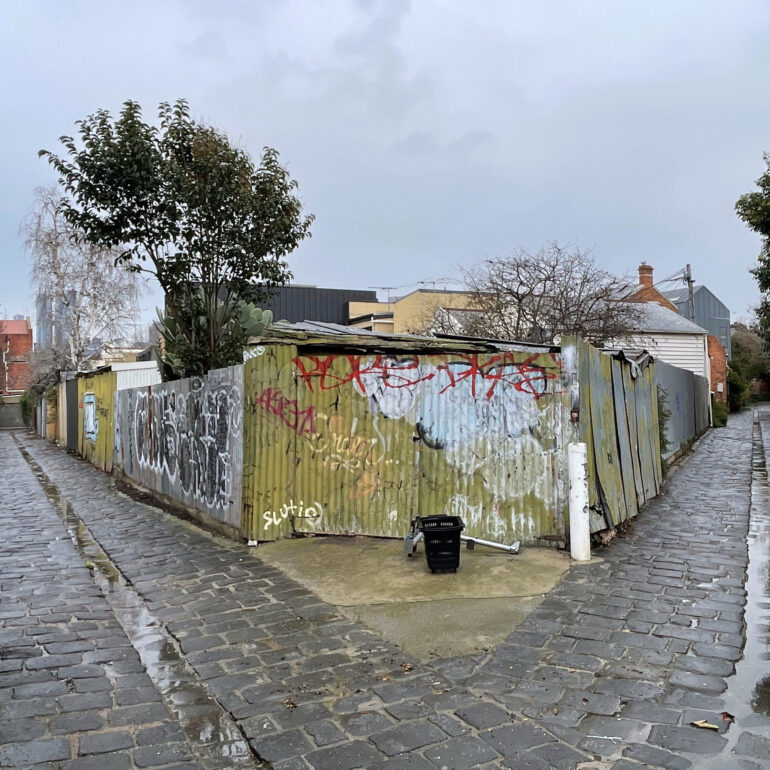 Wet bluestone laneway splitting in two, Melbourne inner north, hidden__north documentary photography