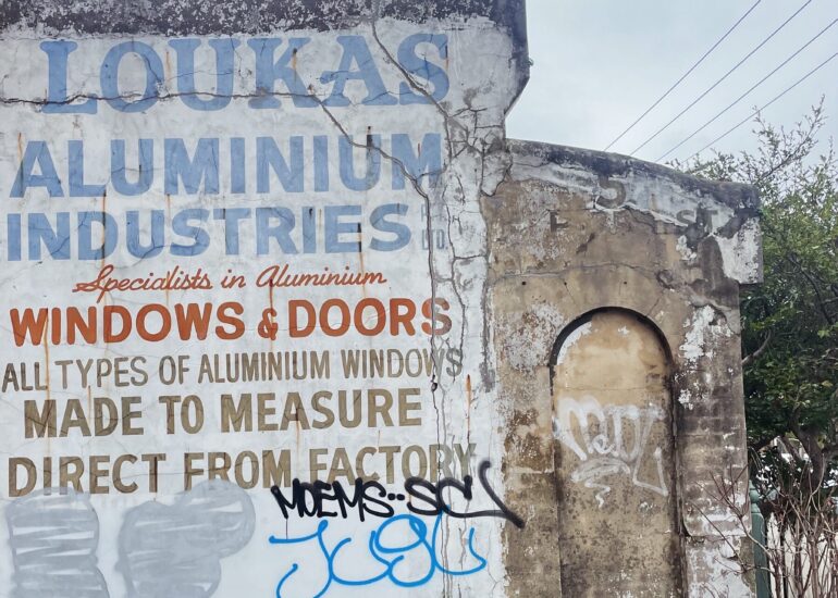 Faded Loukas Aluminium Industries ghost sign on a whitewashed wall, Melbourne inner north, hidden__north documentary photography