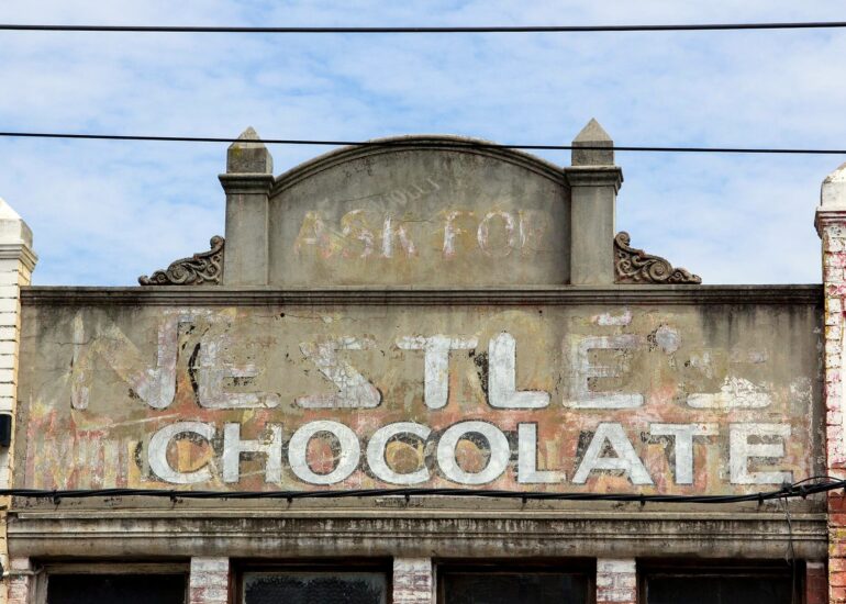 Faded Nestlé chocolate ghost sign above a shopfront, Melbourne inner north, hidden__north documentary photography