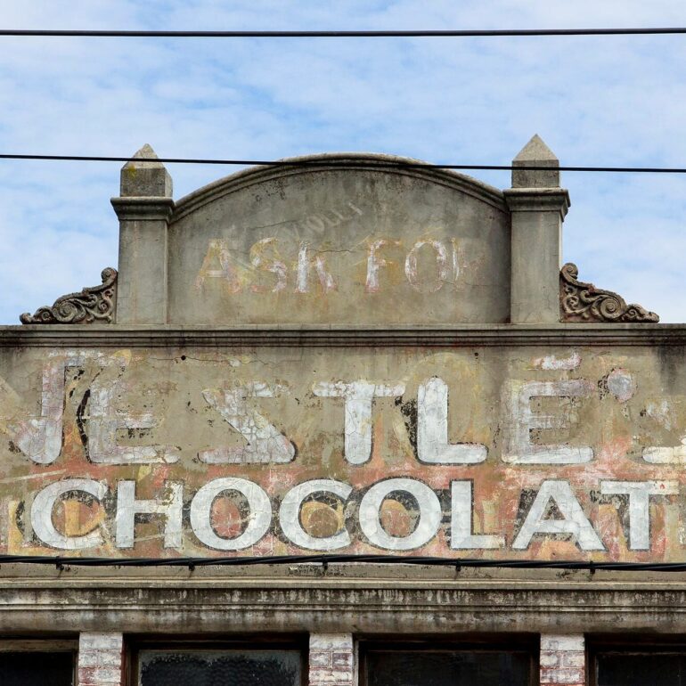 Faded Nestlé chocolate ghost sign above a shopfront, Melbourne inner north, hidden__north documentary photography