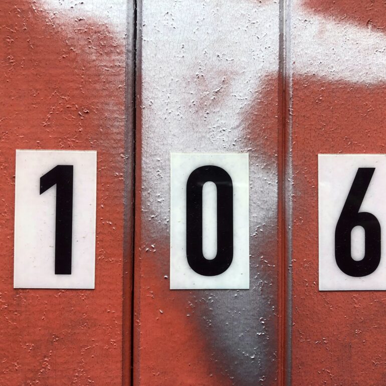 Red painted door, number 106, Melbourne inner north, hidden__north documentary photography