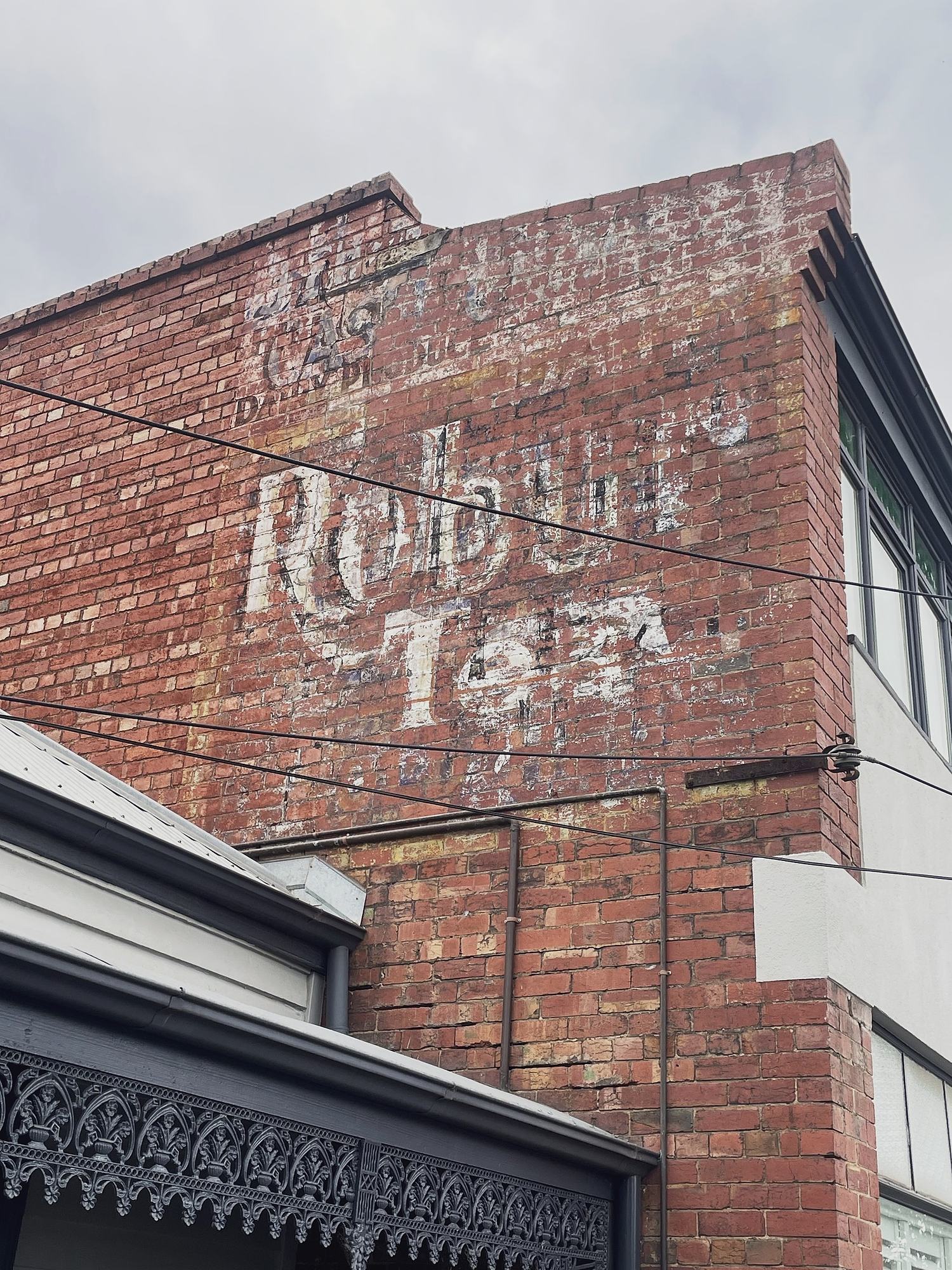Faded Robur Tea ghost sign painted on brick wall, Melbourne, hidden__north documentary photography