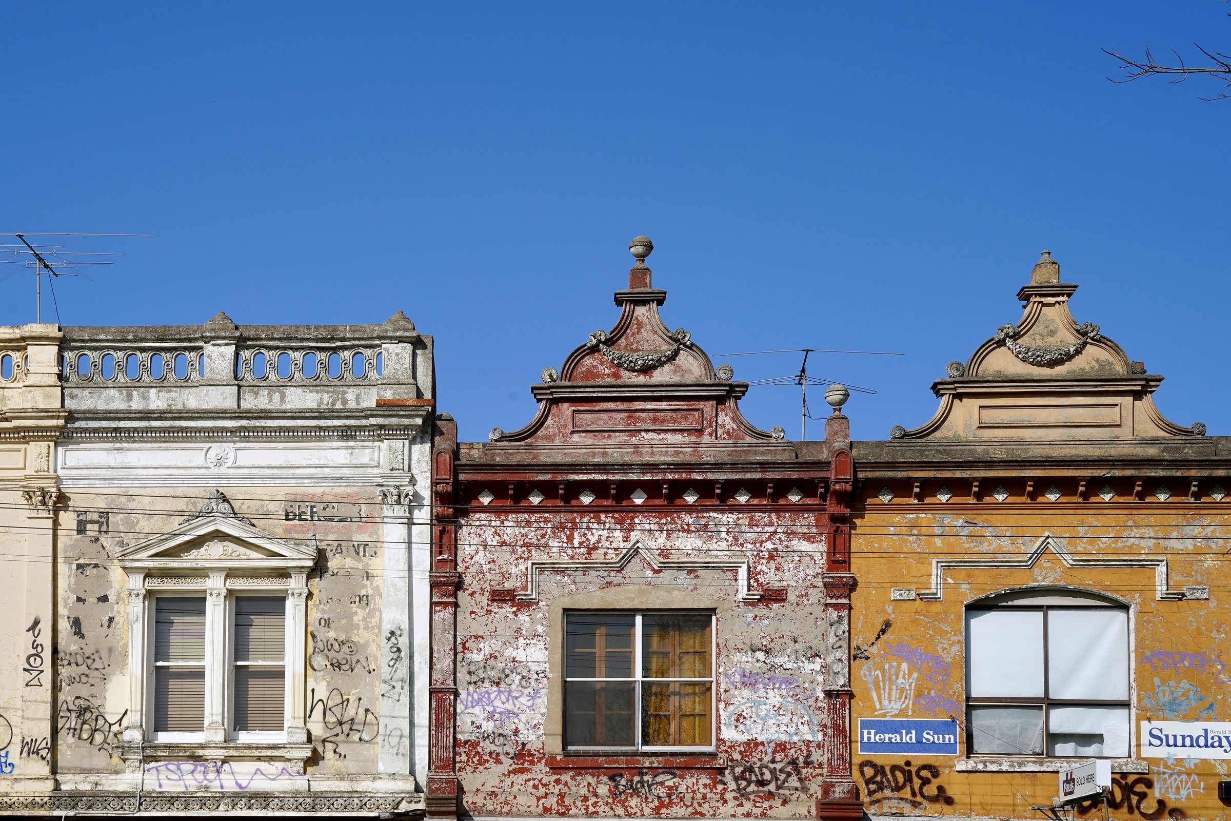 Row of three Victorian parapet shopfronts, Melbourne inner north, hidden__north documentary photography